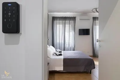 a bedroom with a bed and a tv on a wall at San Paolo Superior Room in Rome