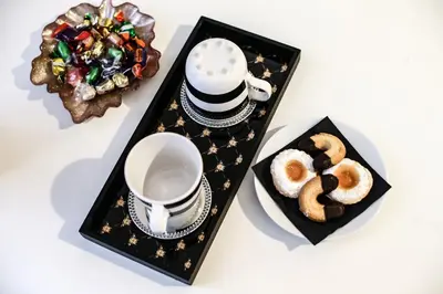 a table with a tray with a cup and a plate of donuts at Relais Circo Massimo in Rome