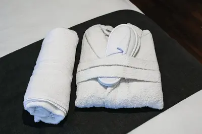 a pile of towels sitting on top of a bed at Relais Circo Massimo in Rome
