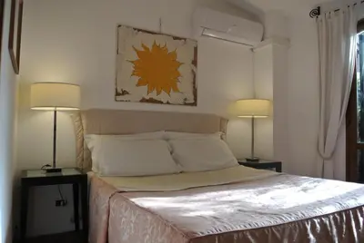 a bedroom with a bed with two lamps on two tables at Appartamento Garden Palatino in Rome