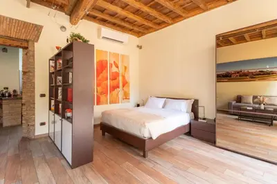 a bedroom with a bed and a couch at Maison Leo a Largo Argentina in Rome