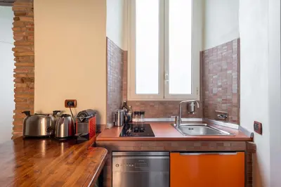a kitchen with a sink and a counter top at Maison Leo a Largo Argentina in Rome