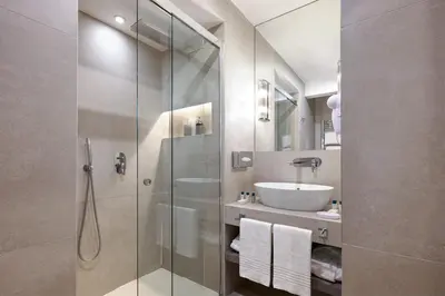 a bathroom with a glass shower and a sink at Terrace Pantheon Relais in Rome