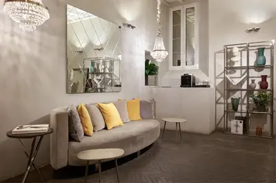 a living room with a couch with yellow pillows at Terrace Pantheon Relais in Rome