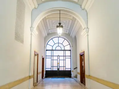 a hallway in a building with a large window at CBMC - Couldn't Be More Central in Rome