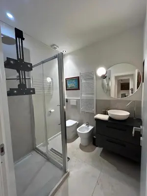 a bathroom with a shower and a toilet and a sink at CBMC - Couldn't Be More Central in Rome