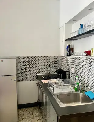 a kitchen with a sink and a counter top at Spacious Studio in Via dei Coronari in Rome