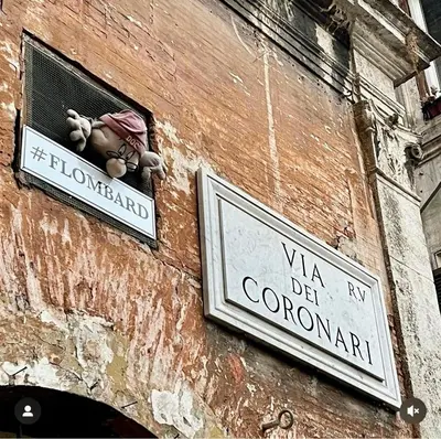 a building with two signs on the side of it at Spacious Studio in Via dei Coronari in Rome