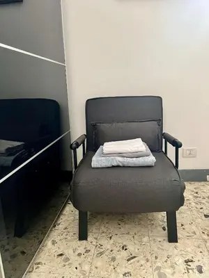 a chair with a towel on it in a room at Spacious Studio in Via dei Coronari in Rome