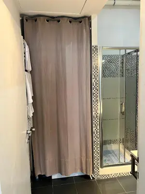 a shower with a shower curtain in a bathroom at Spacious Studio in Via dei Coronari in Rome