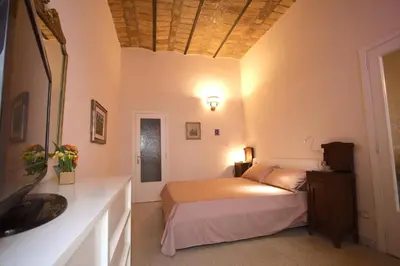 a bedroom with a bed in a room at Manara Holiday House in Rome