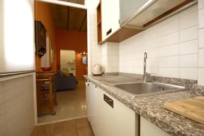 a kitchen with a sink and a counter top at Manara Holiday House in Rome