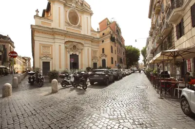 a street with motorcycles parked in front of a church at Manara Holiday House in Rome