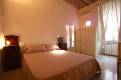 a bedroom with a bed and a window at Manara Holiday House in Rome
