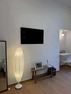 a living room with a flat screen tv on a wall at Flat 7 Rome Guesthouse in Rome