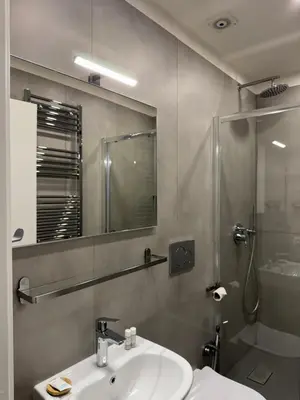 a bathroom with a sink and a mirror and a shower at Flat 7 Rome Guesthouse in Rome