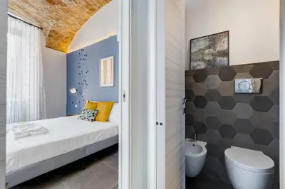 a small bathroom with a bed and a toilet at FaMa - Le Volte in Rome