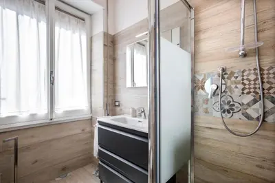 a bathroom with a sink and a mirror at Carpegna Park Apartment by Cornelia subway in Rome