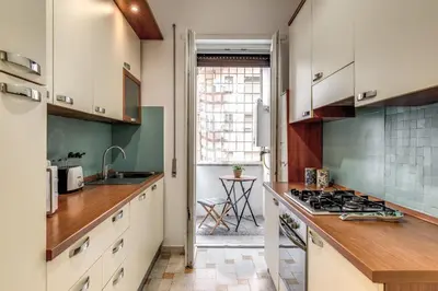a kitchen with white cabinets and a stove at Vatican Cartographer in Rome