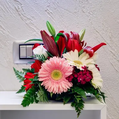 a bouquet of flowers sitting on top of a shelf at V Collection Rome Jubilee Guest House in Rome