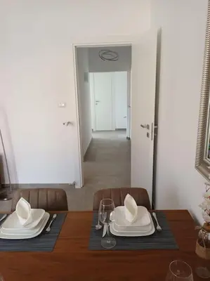 a dining table with white plates and napkins on it at Casa Erminia in Rome