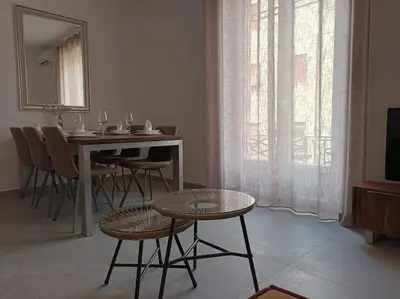 a dining room with a table and chairs and a television at Casa Erminia in Rome