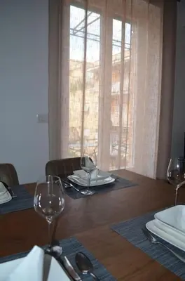 a dining room table with wine glasses on it at Casa Erminia in Rome