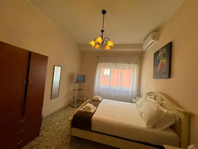a bedroom with a bed and a chandelier at Vintage Charm Apt in Aurelio in Rome