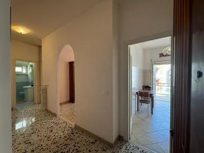 a hallway with a door leading to a dining room at Vintage Charm Apt in Aurelio in Rome