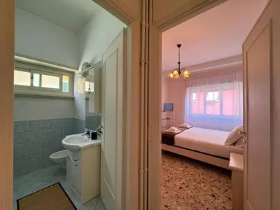 a bathroom with a bed and a sink and a tub at Vintage Charm Apt in Aurelio in Rome