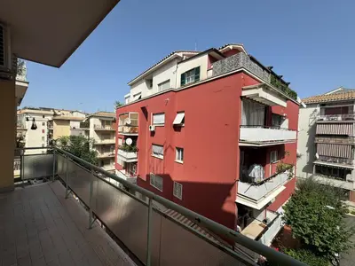 a red building on a balcony with buildings at Vintage Charm Apt in Aurelio in Rome