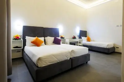 a hotel room with two beds in a room at V Collection Vatican Jubilee Guest House in Rome