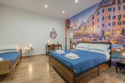 a bedroom with two beds and a painting on the wall at LE TRE M - Guesthouse in Rome