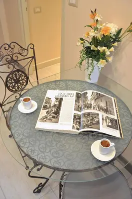 a table with a book and two cups of coffee at Domus Ottavia in Roma in Rome