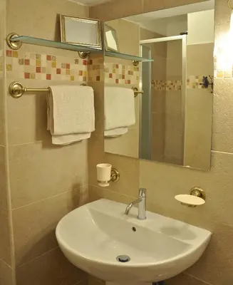 a bathroom with a sink and a mirror and towels at Domus Ottavia in Roma in Rome