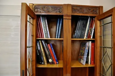 a wooden book shelf filled with books at Domus Ottavia in Roma in Rome