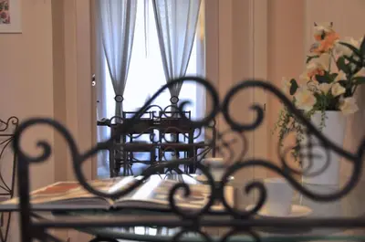 a table with a chair in front of a window at Domus Ottavia in Roma in Rome