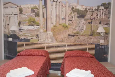 two beds in a room with a view of the acropolis at Ad Maiora bb Roma Musei Vaticani in Rome