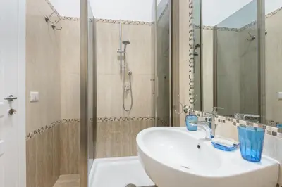 a bathroom with a white sink and a shower at Ad Maiora bb Roma Musei Vaticani in Rome