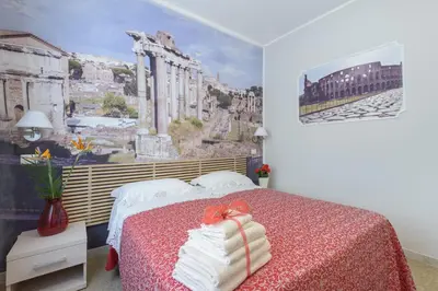 a bedroom with a bed with a painting on the wall at Ad Maiora bb Roma Musei Vaticani in Rome