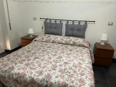 a bedroom with a large bed with a floral bedspread at La casetta di Matteo in Rome