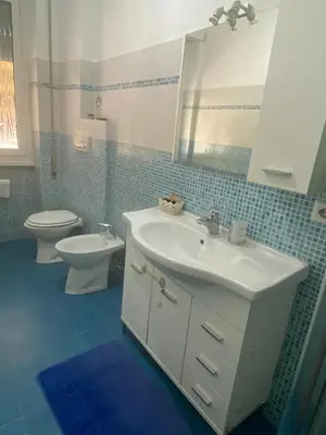 a bathroom with a sink and a toilet and a mirror at La casetta di Matteo in Rome