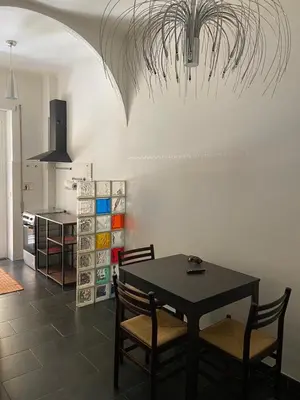 a dining room with a black table and chairs at La casetta di Matteo in Rome