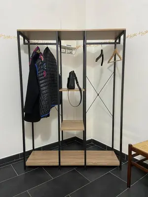 a room with a closet with a shelf and clothes at La casetta di Matteo in Rome