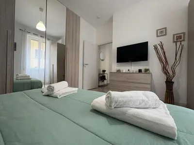 a bedroom with a large bed with two towels on it at RHome Apartment in Rome