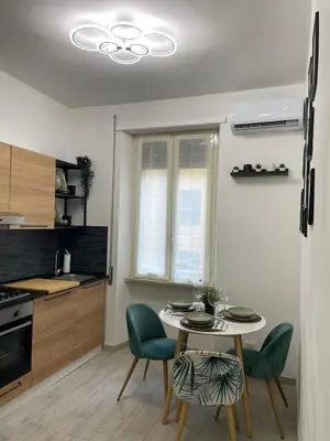 a kitchen with a table and chairs in a room at RHome Apartment in Rome