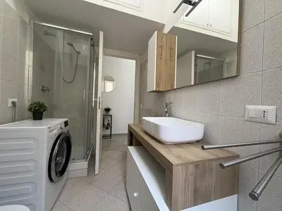 a bathroom with a sink and a mirror at RHome Apartment in Rome