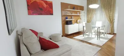 a living room with a white couch and a table at Colosseo Dream in Rome