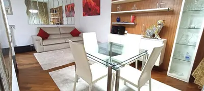 a living room with a glass table and a couch at Colosseo Dream in Rome