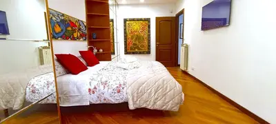 a bedroom with a bed and a mirror at Colosseo Dream in Rome